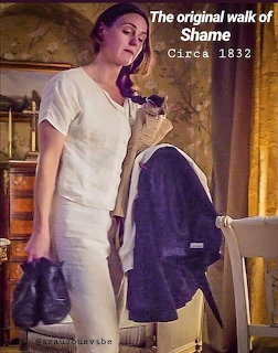 Woman in a white dress holding black shoes indoors beside a chair and draped clothing