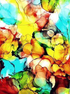 Abstract alcohol ink art with vibrant yellow, orange, turquoise and red flowing organic patterns