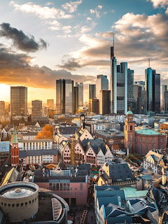 Frankfurt cityscape with skyscrapers and traditional buildings at sunset