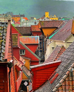 Aerial view of colorful traditional rooftops in Bergen, Norway with red and orange wooden buildings