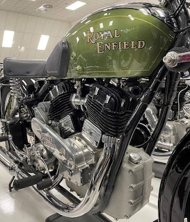 Green Royal Enfield motorcycle tank and chrome V-twin engine detail