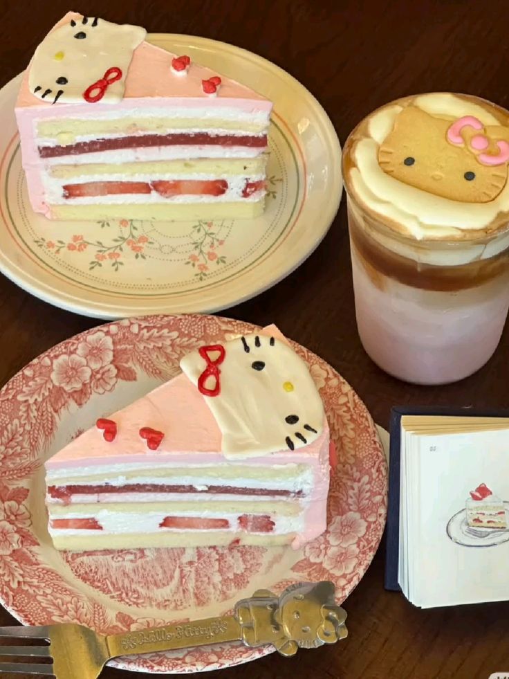 Two Hello Kitty cake slices with pink frosting and strawberry layers next to a Hello Kitty-topped latte drink