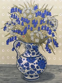 Illustration of blue grape hyacinths and white flowers in decorative blue and white ceramic vase