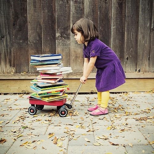 Girl Pulling Books on Wagon