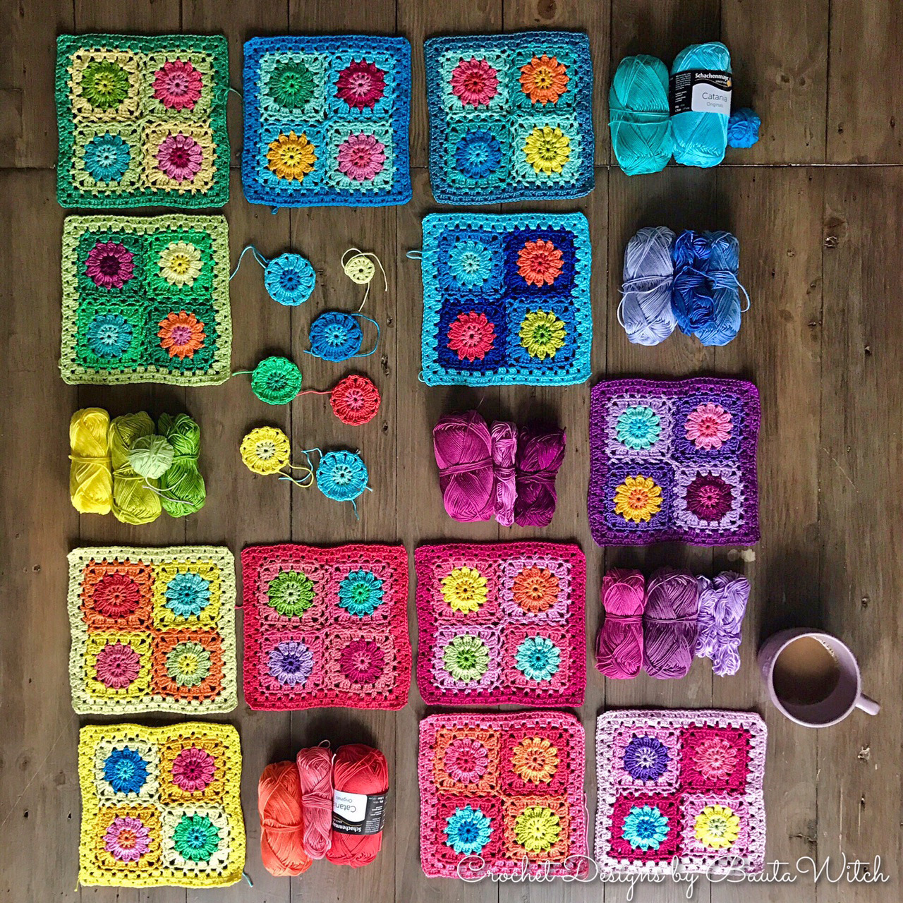 Colorful crochet granny squares and yarn arranged in wooden grid compartments