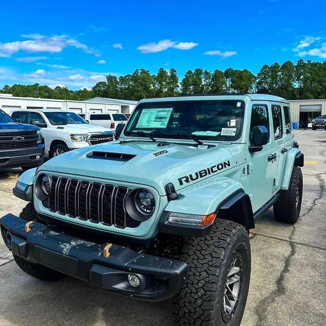 Light blue off-road SUV parked in a vehicle lot under a blue sky