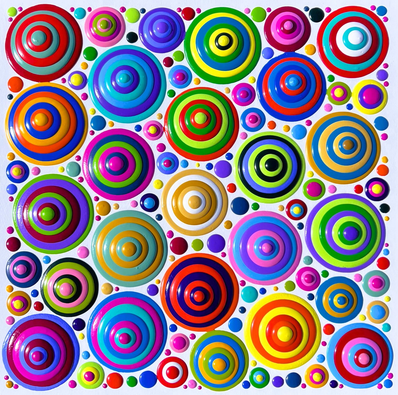 Abstract art with colorful concentric circles and dots in various sizes arranged on white background
