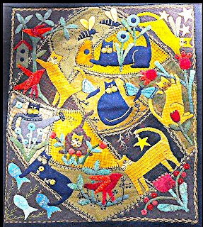 Colorful traditional painting of Ganesha, Hindu elephant god, in yellow with blue ornamental details and floral border