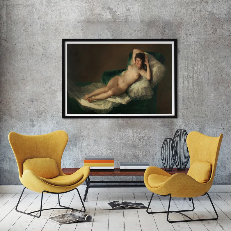 Modern living room with two yellow chairs, small table, and framed classical painting on gray wall