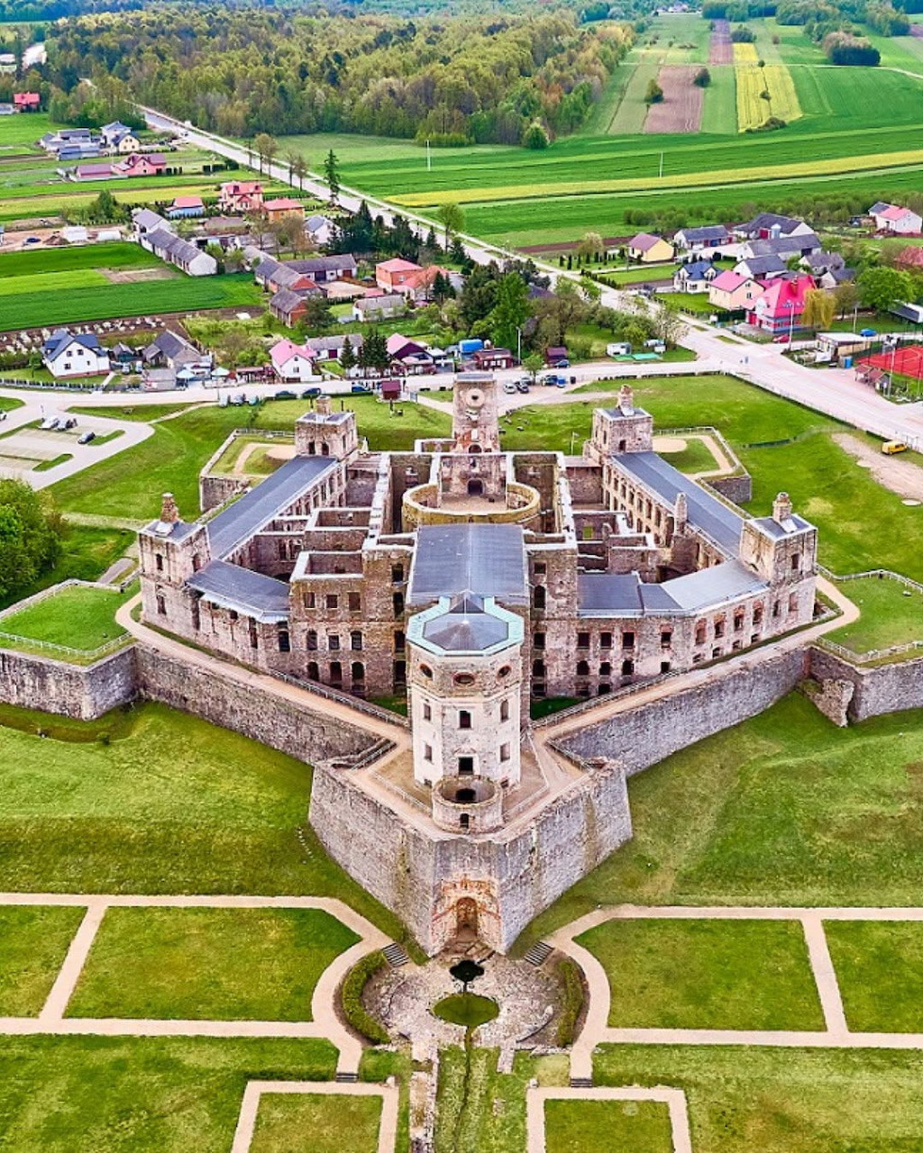 Aerial view of Krzyżtopór Castle ruins in Ujazd, Poland, with surrounding gardens and village
