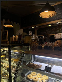 Interior of Ama Cafe in a Delhi market with warm lighting and wooden decor