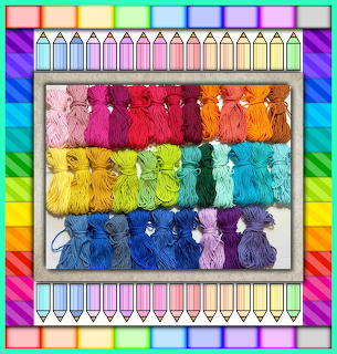Colorful embroidery thread skeins arranged in rainbow gradient rows with decorative border