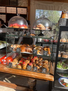 Glass display case filled with assorted pastries and baked goods at a café counter