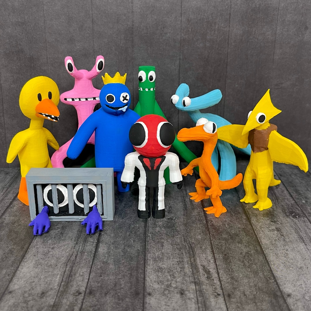 Group of colorful handmade clay character toys with quirky designs on wooden floor