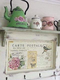 Vintage kitchen with wooden shelves, ceramic dishes, copper pots and dried herbs