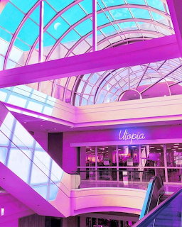 Bright pink and purple vaporwave-styled mall interior with curved glass ceiling and neon lighting