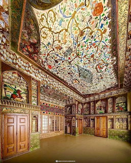 Ornate Persian interior with elaborate painted floral ceiling and carved wooden walls