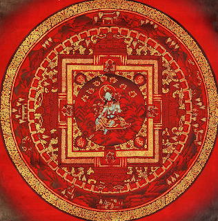 Detailed red and gold mandala with central deity figure surrounded by concentric geometric patterns and symbolic imagery