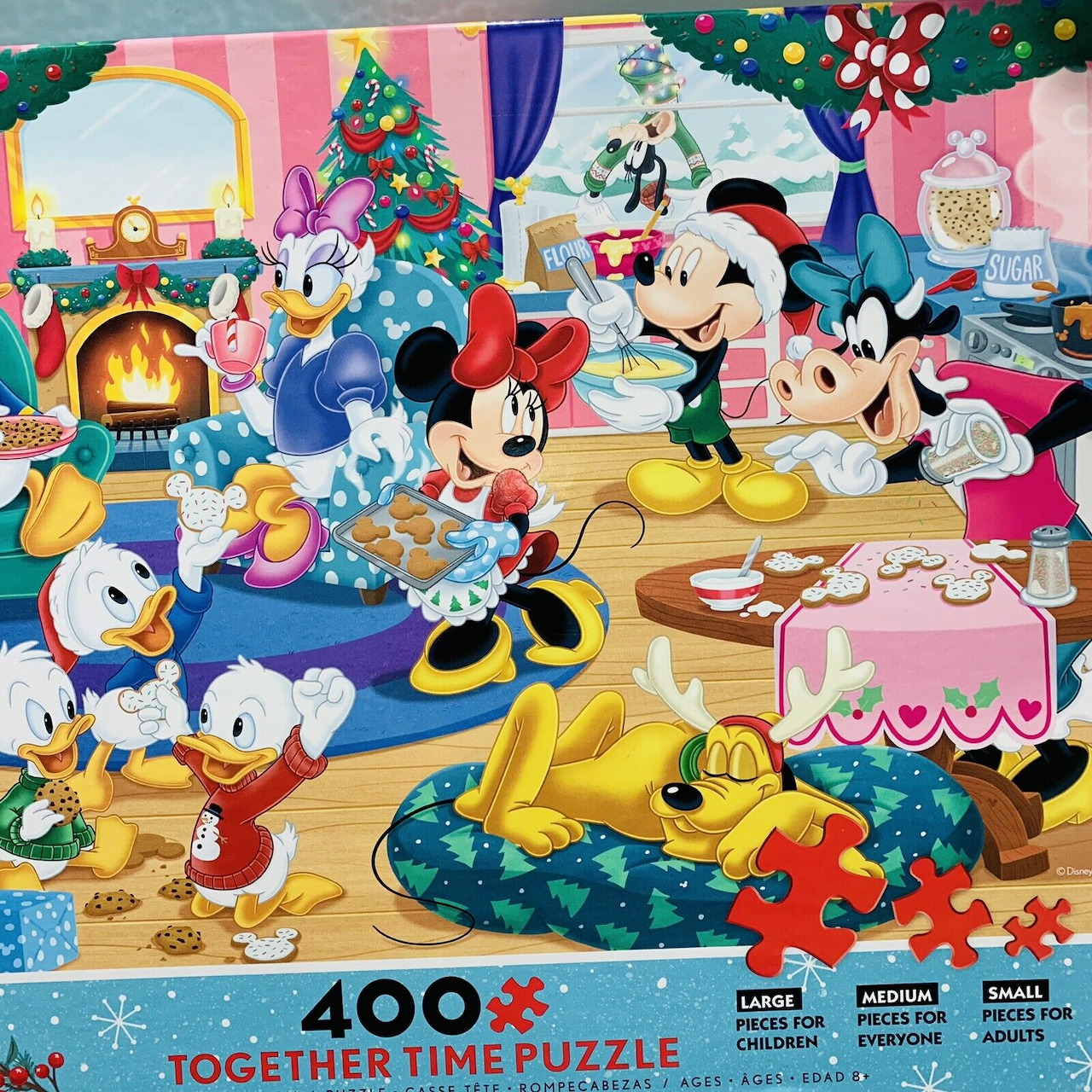 Disney characters at a Christmas party in a festive living room with a tree, cake, presents, and Pluto resting