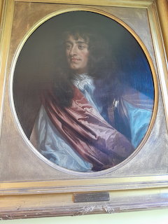 Oil painting portrait of King James II in royal dress within an oval gold frame