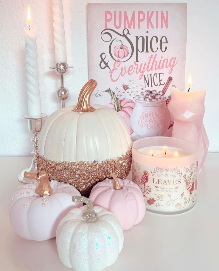 Pastel pink and white pumpkins with candles and pumpkin spice sign in soft autumn decor arrangement