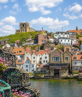 Harbor houses and a church on the hillside in Robin Hood's Bay, England