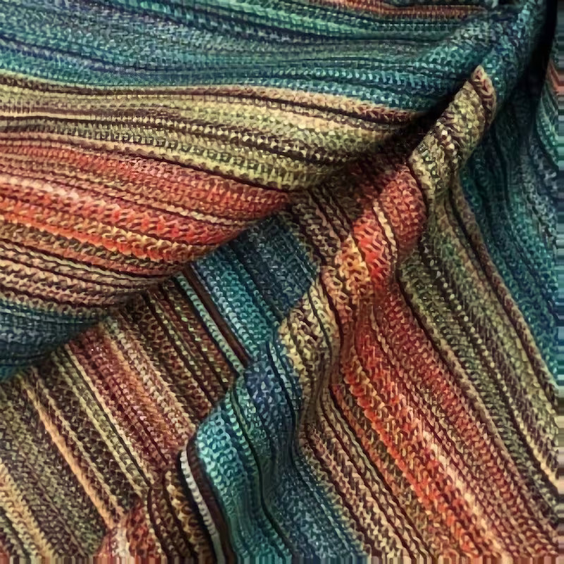 Close-up of colorful striped knitted fabric folded in soft waves