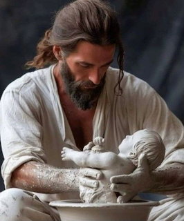 Bearded man sculpting a clay baby figure on a pottery wheel