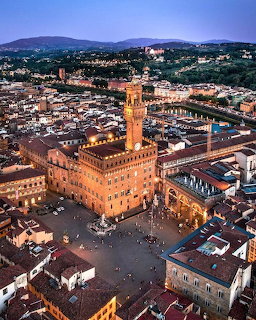 Aerial dusk view of Palazzo Vecchio tower and Piazza della Signoria in Florence, Italy
