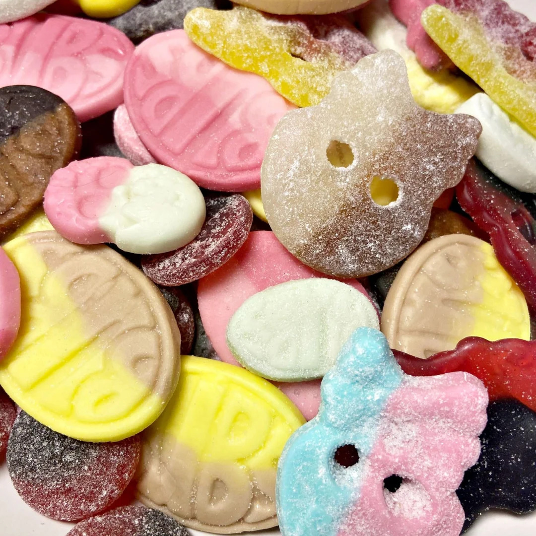 Assorted colorful Swedish candy pieces including gummy, foam, and sugar-coated sweets in various shapes
