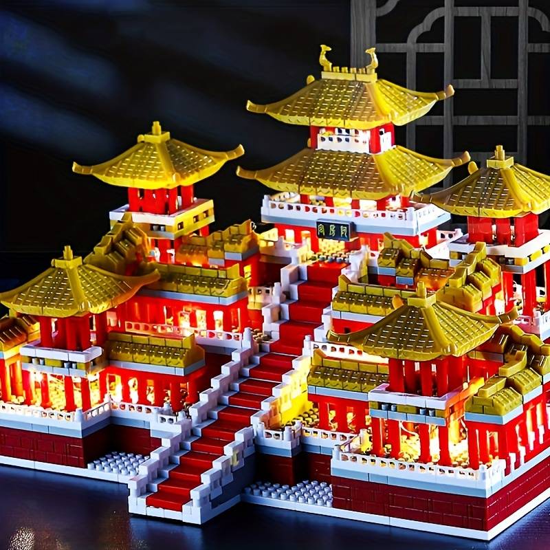 Colorful model of an East Asian temple complex with golden roofs and red staircases