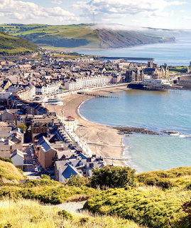 Aerial view of Aberystwyth seaside town on Cardigan Bay with beach and hills