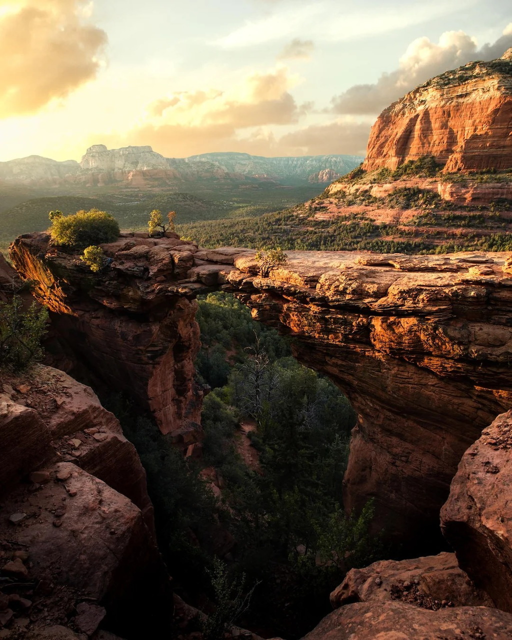 Devil's Bridge natural sandstone arch in Sedona Arizona with red rocks and sunset sky