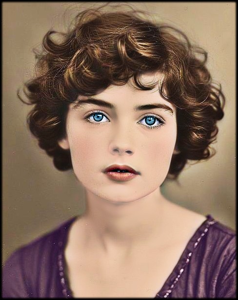 Colorized vintage portrait of a young woman with curly brown hair and blue eyes in a purple dress