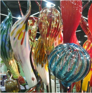 Colorful blown glass sculptures with swirled patterns displayed indoors