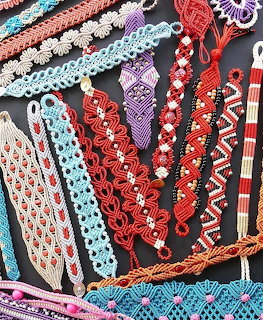 Assortment of colorful crocheted lace bookmarks with various patterns displayed on dark background