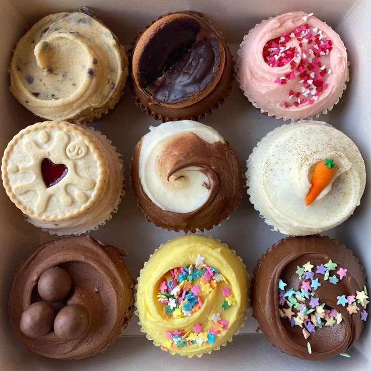 Nine cupcakes with assorted frosting flavors and colorful toppings in a 3x3 grid
