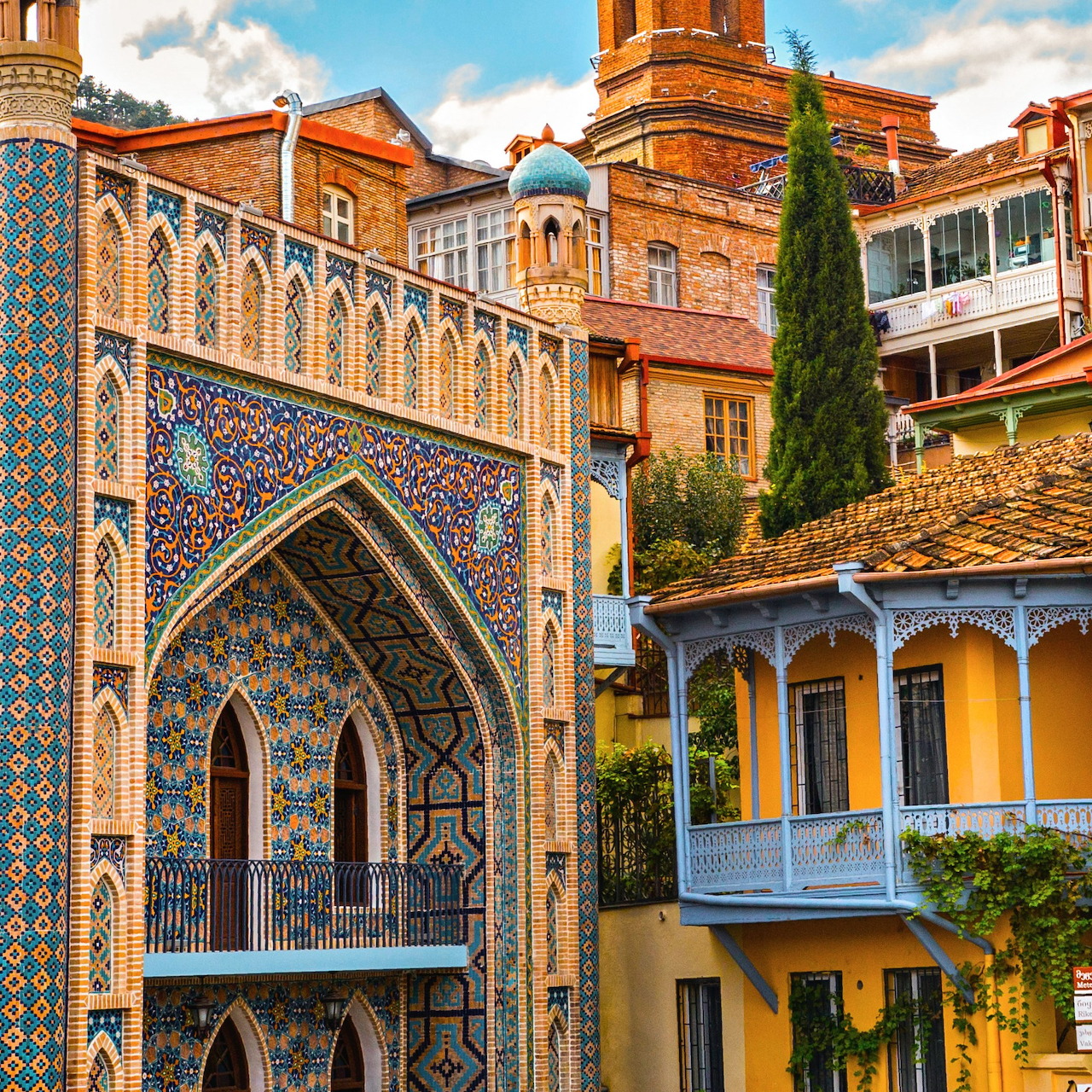 Ornate historic buildings with decorative tiles and arches in Tbilisi, Georgia