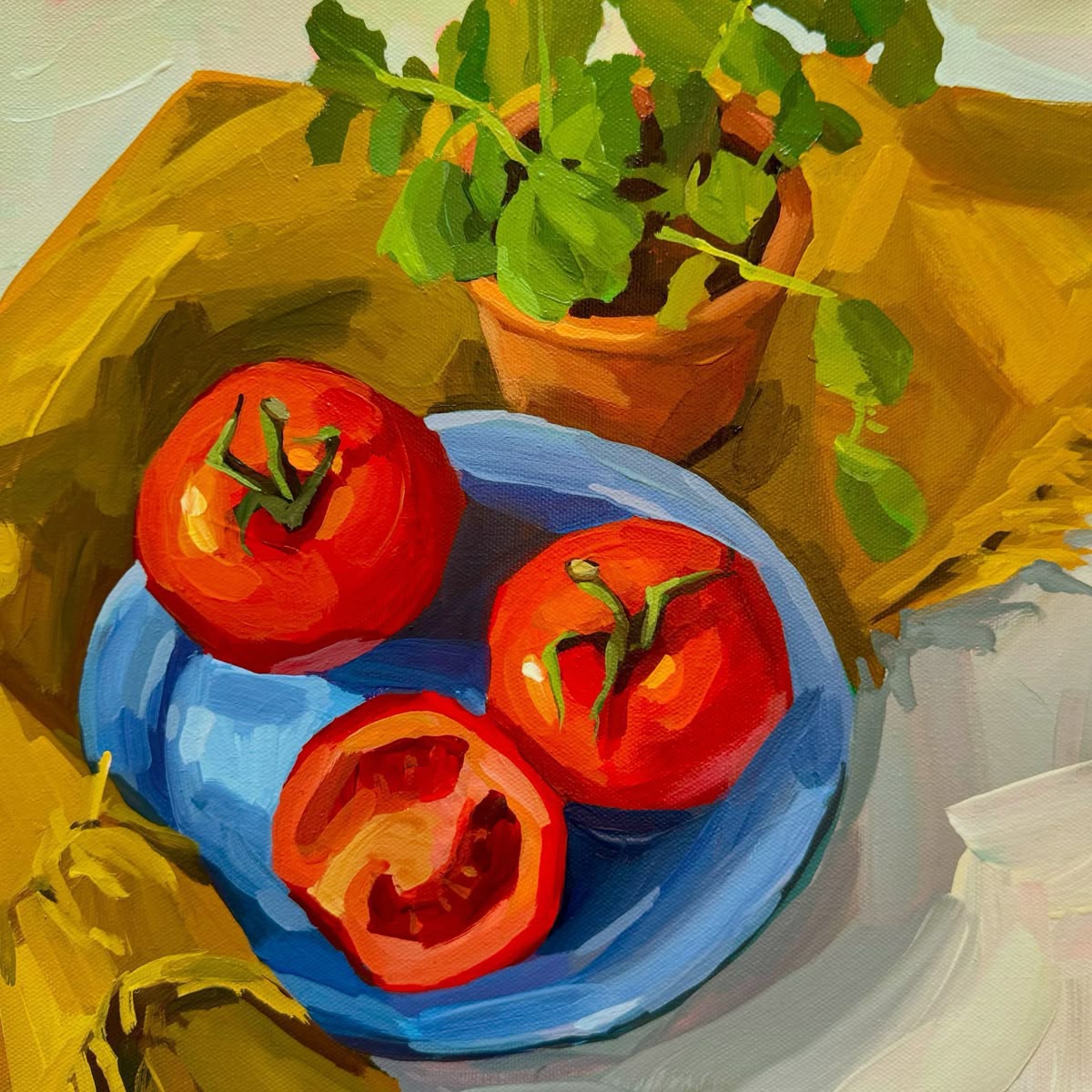 Painting of red tomatoes on a blue plate with a small potted herb and yellow cloth