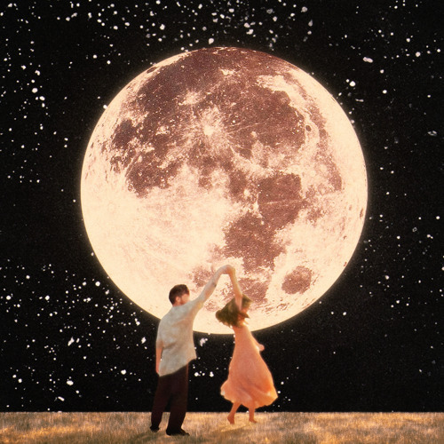 A couple dancing in front of a giant full moon under a starry night sky
