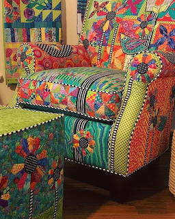 Brightly colored patchwork armchair with geometric patterns, florals and stripes, plus matching ottoman