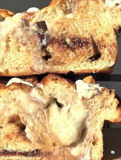 Close-up of toasted bread slices with white icing or glaze dripping over golden-brown crust