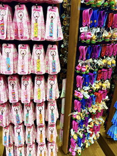 Rows of colorful Hello Kitty keyrings and novelty keychains on store display racks