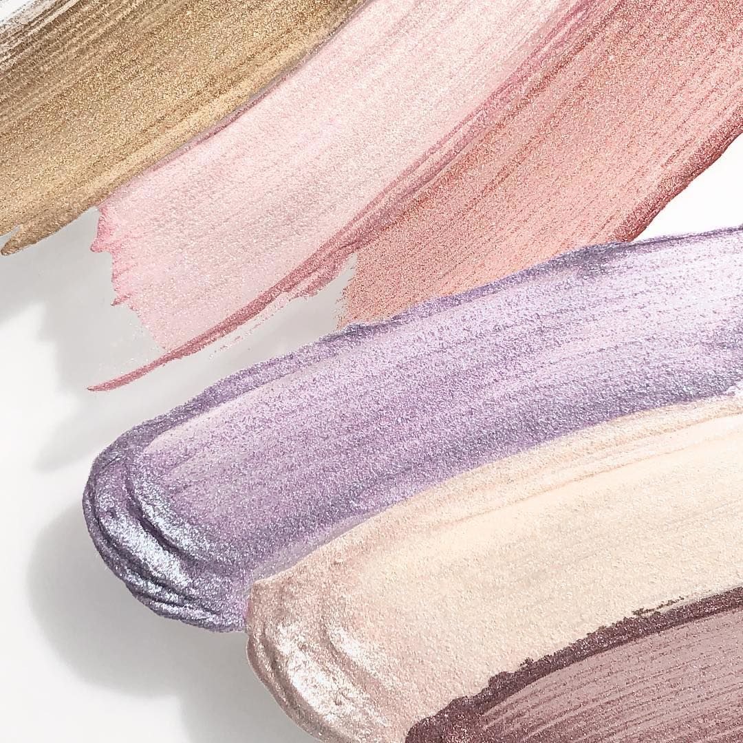 Diagonal makeup smudges in nude pink beige and lavender tones with shimmer texture