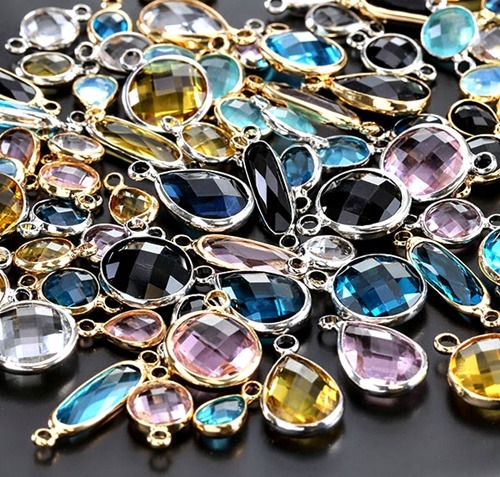 Close-up of colorful faceted glass stones in metal bezel link settings