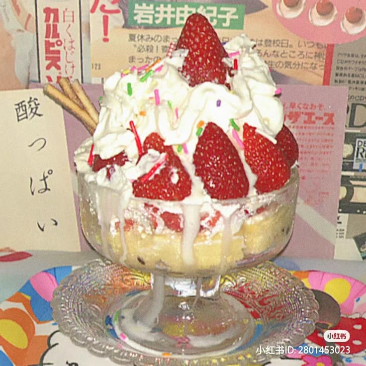 Strawberry parfait topped with whipped cream, strawberries, and sprinkles in a glass dessert cup