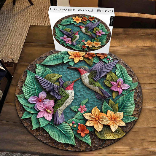 Round puzzle with hummingbirds and flowers on a wooden table next to the matching box