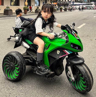 Child on Green Toy Motorcycle