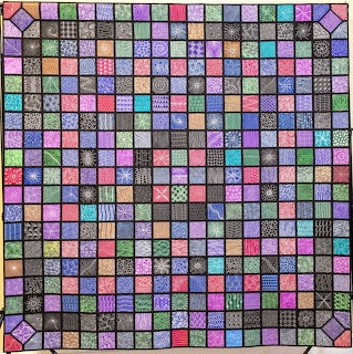 Colorful patchwork quilt with many small patterned squares and stitched designs