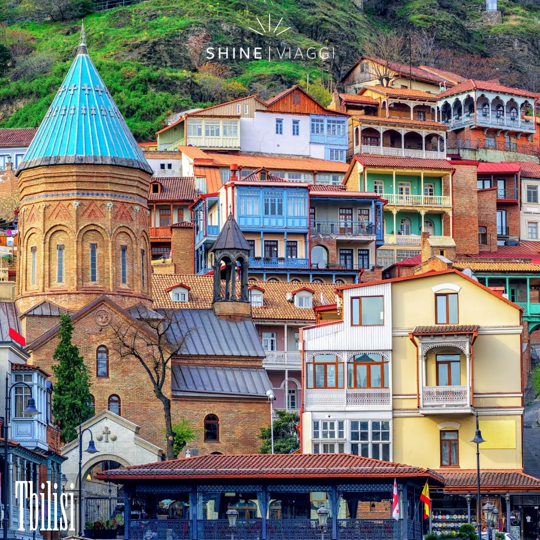 Colorful traditional buildings with ornate balconies clustered on hillside in Tbilisi, Georgia